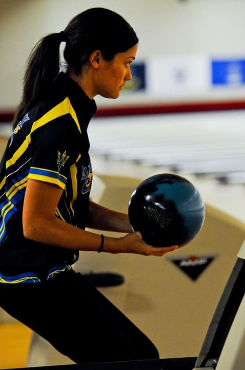 Woman about to release bowling ball