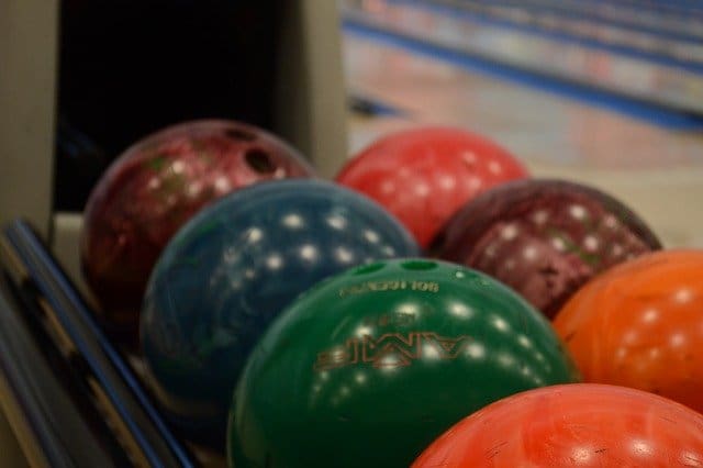 Close up photo of bowling balls in ball return
